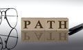 Close-up Of PATH Wooden Blocks on the black background with glasses and pen Royalty Free Stock Photo