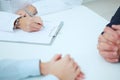 Close up of patients hands and doctor taking notes. Royalty Free Stock Photo