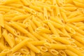 Pattern made of raw penne rigate pasta Royalty Free Stock Photo