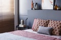 Close-up of patterned pillows lying on a soft bed in bedroom int Royalty Free Stock Photo