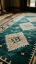 Close up of a patterned rug with geometric shapes in shades of blue and beige on a floor surface Royalty Free Stock Photo