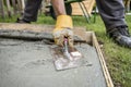 Close up on paver smoothing fresh concrete
