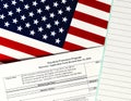 Close-up of paycheck protection program borrower application form revised topview, on a background of United States flag. paycheck