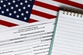 Close-up of paycheck protection program loan forgiveness application form revised topview, on a background of United States flag. Royalty Free Stock Photo