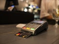 Close up payment machine on the table for paying bill by at table. wireless pos terminal with card Royalty Free Stock Photo