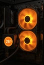 Close-up of a PC cooling system with two orange-lit fans and a display showing the temperature at 26ÃÂ°C, inside a computer case Royalty Free Stock Photo
