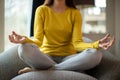 Close Up Of Peaceful Woman Meditating Sitting In Chair At Home