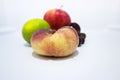 Close up of a peach in a fridge.