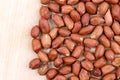 Close up of peanuts. Wooden plate.