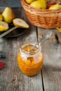 Close up Pear jam and fresh yellow ripe pears on old rustic wooden table. Autumn harvest still life concept. Selective focus. Royalty Free Stock Photo