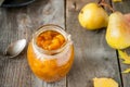 Close up Pear jam and fresh yellow ripe pears on old rustic wooden table. Autumn harvest still life concept. Selective focus. Spac Royalty Free Stock Photo