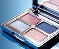 A close-up of pearlescent shimmery palette of blue eyeshadows for creating eye makeup.