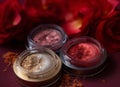 A close-up of pearlescent shimmery red,pink and orange glitter eyeshadows for creating eye makeup