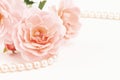 Close up of pearls and pink roses