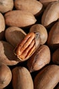 close up of pecan nuts in shell, one nut cracked, background Royalty Free Stock Photo