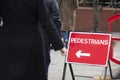 Close-up of pedestrians arrow sign on sidewalk