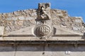 Close-up of the pediment with symbol of sun worship or solar wheel Royalty Free Stock Photo