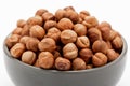 Close-up of peeled hazelnuts in a bowl isolated on white