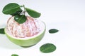 Close-up of a Peeled Pomelo with Leaves on a White Background Royalty Free Stock Photo