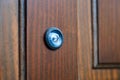 Close-up of a peephole on a wooden door Royalty Free Stock Photo