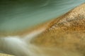 Close-up, Pemigewasset River flowing around orange granite, New