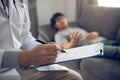 Close up of pen doctor writing with came to visit the patient at home while he was suffering from stomach ulcers and noted the tre