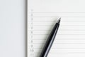 Close-up of pen on empty note paper sheet, white note pad with n Royalty Free Stock Photo