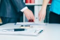 Close-up the pen lies on the documents. Business people hands pointing analyzing at the documents on the background Royalty Free Stock Photo