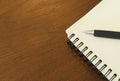 Close up of Pen with notebook blank page on wood table backgrounds Royalty Free Stock Photo