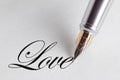 Close up of a pen writing the word love Royalty Free Stock Photo