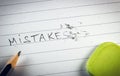 Close up of pencil eraser correcting and fixing word Mistakes Royalty Free Stock Photo