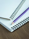 Close up pencil and spiral notebook on wood table Royalty Free Stock Photo