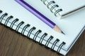 Close up pencil and spiral notebook on wood table Royalty Free Stock Photo