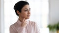 Close up of pensive indian female look in distance thinking Royalty Free Stock Photo