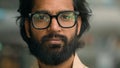 Close up pensive thoughtful calm Indian man in eyeglasses spectacles thinking dreaming looking to side. Portrait serious Royalty Free Stock Photo