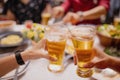 Close-up of people cheering of beer at a party. Group of Asian people having a New Year`s party at home