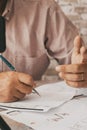 Close up of people doing online contents using phone and little tripod. Man writing on paper notes. Concept of online job and Royalty Free Stock Photo