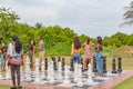 Close up of people on a ground Chess board