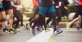 Close up of People`s Feet Running Marathon Race on City Road. Motion Blur.