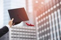 Close up people show hand hold show hat in background School building. Shot of graduation cap during Commencement University Degre Royalty Free Stock Photo