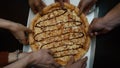 Close up of people taking slices of different pizzas. Group of multi ethnic friends eating Italian pizza take away Royalty Free Stock Photo