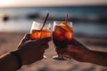 Close up of people toasting with alcoholic drink on a beach, created with Generative AI technology. Royalty Free Stock Photo