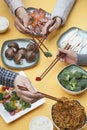 Close up of people using chopsticks with Chinese food