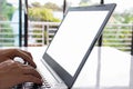 Close-up, People work home blogger. A man sits and typing a document with a notebook computer on a white table in the living room Royalty Free Stock Photo