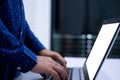 Close-up, People work home blogger. A man standing and typing a document with a notebook computer on a white table in the living Royalty Free Stock Photo