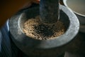 Close up of peppers being crushed in a mortar Royalty Free Stock Photo