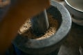 Close up of peppers being crushed in a mortar Royalty Free Stock Photo