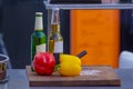 close-up of peppers on cutting board with beer bottles behind Royalty Free Stock Photo