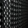 Close-up of a perforated metal sheet with circular holes arranged in a grid pattern. Royalty Free Stock Photo