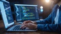 Programmer working on multiple computer screens at night Royalty Free Stock Photo